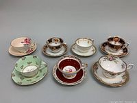 Seven Paragon bone china teacup and saucer sets arranged in two rows showing the variety of colors and patterns.
