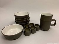 Full set photo showing 5 cereal bowls stacked, 5 egg cups in front, and 6-inch pitcher on right