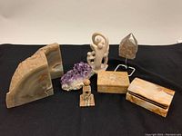 Photo of entire lot showing two bookends, amethyst geode, stone boxes, abstract figurine, and pointed crystal on stand