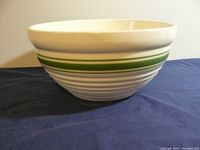 Side view of the mixing bowl showing green and gray ring decorations and ribbed texture.