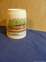 View of the front and side of the antique ceramic mug with Seal Ice Hotel illustration and Harrison Hot Springs, British Columbia text.