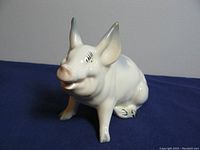 Front angled view of the Beswick ceramic pig figurine showing face, ears, and front legs.