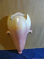 Front view of Royal Winton wall pocket showing tulip-shaped iridescent ceramic with gold rim and pink tones.