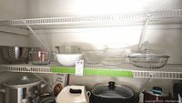 Shelving with all bowls, measuring cups and casserole displayed
