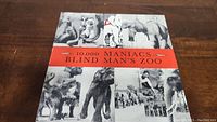 Front cover of 10,000 Maniacs Blind Man's Zoo album showing black and white elephant collage and red title band.