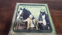 Front cover of Jethro Tull Heavy Horses vinyl album showing man with two horses and album title.