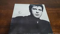 Black and white portrait cover of Peter Gabriel on vinyl album titled 'So'