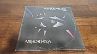 Front cover of Steve Miller Band's Abracadabra album showing stylized eye design on black background