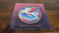Front cover of Steve Miller Band Book of Dreams vinyl album showing Pegasus artwork and band name.