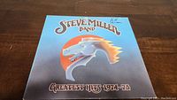 Front cover of Steve Miller Band Greatest Hits 1974-78 vinyl album showing stylized horse head graphic and title text.