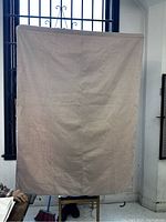 Curtain 1 hanging in front of window, beige, plain fabric, slightly wrinkled