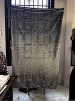 Front view of one large silver velvet curtain hanging, showing fabric texture and size relative to nearby window and furniture.