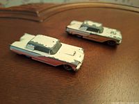 Two vintage Ford Thunderbird toy cars side by side showing paint wear and condition.