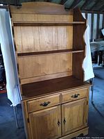 Full view of the two-piece wooden buffet showing bottom cabinet with drawers and top open shelving unit