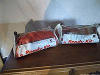 Two Ready Emergency Kits inside clear plastic-zipped cases with Salvation Army labels.