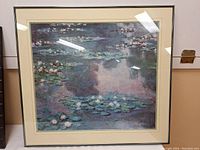Full view of the framed print depicting water lilies on a pond, showcasing the colors and framing.