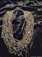 Full view of the 20-strand beaded necklace showing the strands and bead arrangement.
