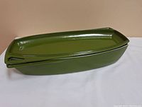 Green rectangular casserole dish with matching lid, side view showing lid fitting