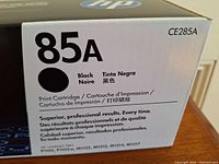 Close-up of the front side of the toner cartridge box showing model number 85A and black color indicator.