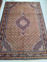 Full view of rug laid flat showing central medallion, field pattern and multi-border