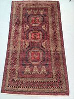 Full top-down image of the Persian Balouch rug showing the entire design and borders.