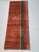 Full-length view of the runner rug laid flat on a light surface, showing overall color and stripe pattern.