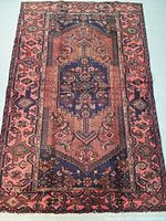 Full view of the hand knotted Persian wool rug showing intricate designs and colors.