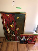 Both paintings side by side against wall