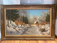 Full view of framed winter landscape painting by Otto Eilertsen showing snow, trees, cabin, and path, with ornate gold frame visible