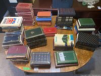 Full view of all hardcover books arranged on table showing various bindings, titles, and colors.