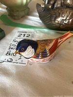 Side view of Royal Crown Derby bird figurine showing detailed pattern and colors.