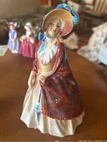 Front view of Royal Doulton HN1987 Paisley Shawl figurine showing detailed facial features and shawl.