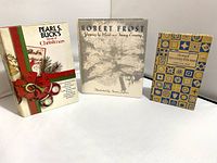 Photo showing all three books standing upright, covers visible: Pearl S. Buck's Christmas, Robert Frost winter poem, The Story of the Other Wisemen.