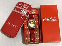 Full view of Coca-Cola watch in vending machine style tin with original box shown