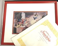 Framed lithograph featuring Snow White and the Seven Dwarfs with attached original paper frame and envelope on back.