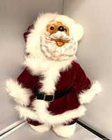 Full body photo of the Santa bear figurine showing red velvet outfit and white faux fur trim