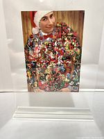 Front of the holiday card showing Pee-wee Herman in a Santa hat, with a colorful and detailed festive decoration covering his torso.