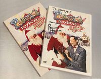 DVD case with signed front cover and original sleeve showing Pee-wee Herman and Santa Claus.
