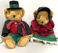 Front view of both teddy bears side by side showing their holiday-themed outfits and detailing