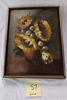 Full view of the framed oil painting showing sunflowers in a vase, with some scratches visible on canvas.