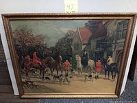 Full view of the framed hunting party lithograph showing horses, riders, and dogs in a countryside setting, with an ornate gold frame.