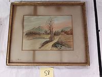 Full view of the framed watercolor painting showing the scenic landscape with pathway, trees, water, and mountains, along with the matting and frame.