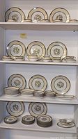 Photo showing multiple shelves of Noritake Argosy plates and bowls arranged by size