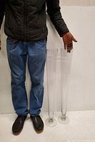 Full view showing the two tall crystal vases alongside a person for scale.