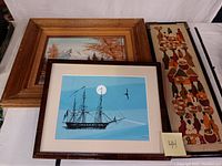 Overview photo showing all three framed artworks together: forest and mountain oil painting, ship silkscreen print, and tall batik art.