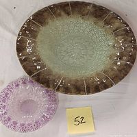 Overhead view showing the larger fused glass dish's pattern and color gradient alongside the smaller lavender bowl