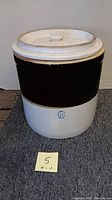 Full frontal view of the stoneware crock with lid, showcasing its two-tone glaze and number 6 mark.