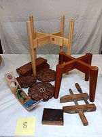 Lot of assorted wooden miscellaneous items including carved trivets, a trinket box, a hand-painted craft, wooden stands, and an etched copper plate stamp.