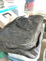 Black zippered storage bag containing holiday figures