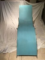 Front view of lounge chair showing light blue nylon mesh fabric and aluminum frame against white backdrop.